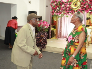 Vernita and Llewellyn Cooke dancing, with Brian in the background
