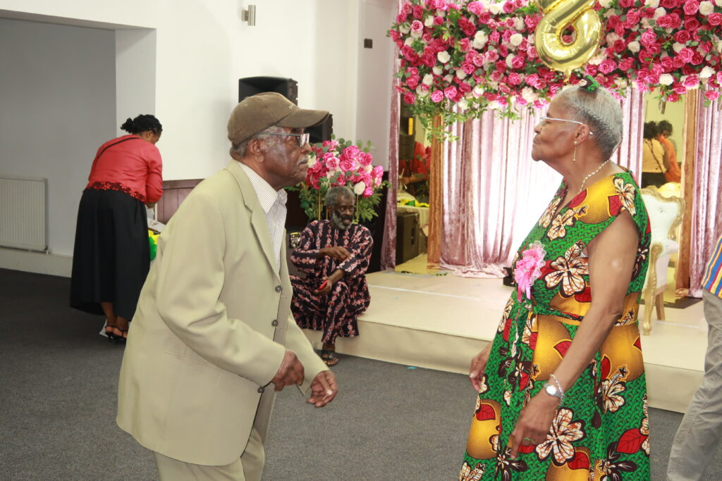 Vernita and Llewellyn Cooke dancing, with Brian in the background